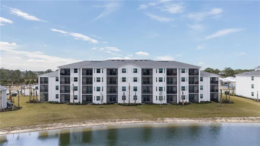View of apartment building / complex featuring a water view