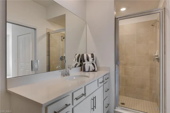 Full Master bath with vanity and a stall shower