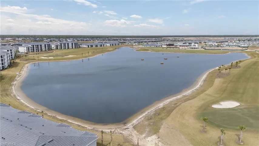 Drone / aerial view of a local golf course and a large body of water