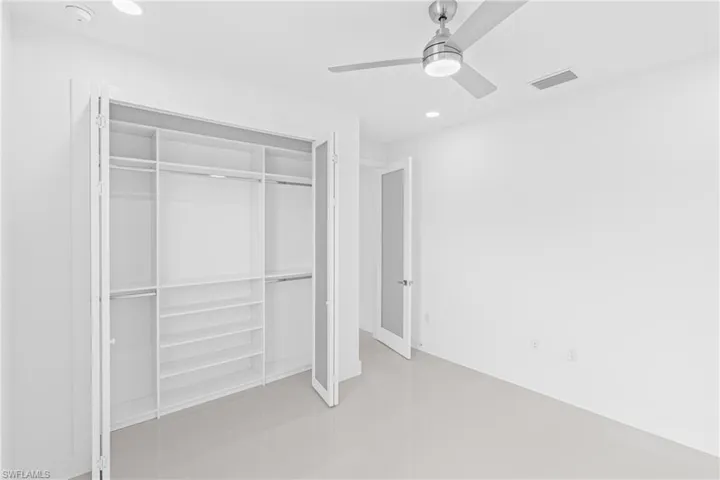 Unfurnished bedroom featuring recessed lighting, a ceiling fan, a closet, and concrete floors