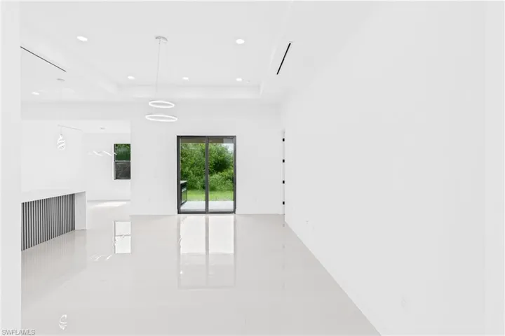 Spare room featuring recessed lighting and a raised ceiling