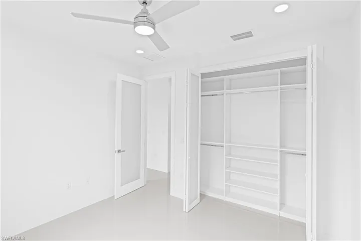 Unfurnished bedroom featuring recessed lighting, a ceiling fan, and a closet