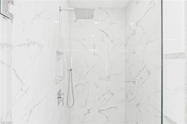 Bathroom view of a marble finish shower