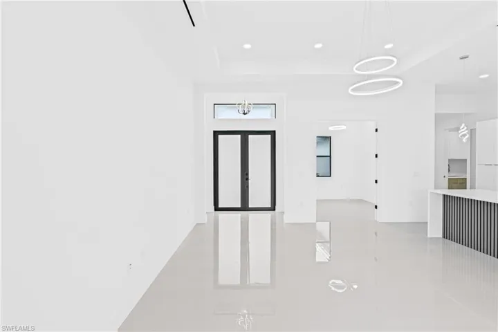 Entryway with recessed lighting and a raised ceiling