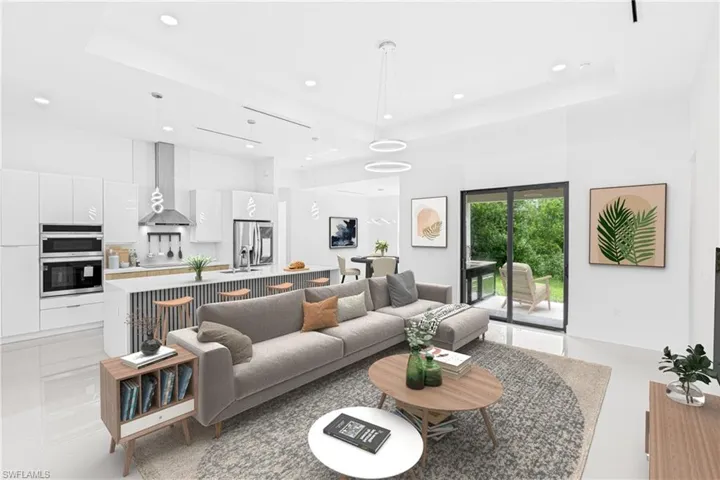 Living area featuring recessed lighting and a high tray ceiling