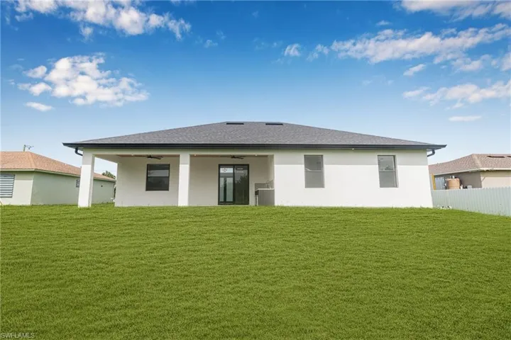 Back of house featuring ceiling fan, a patio, stucco siding, and a shingled roof