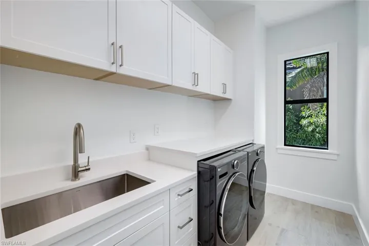 Laundry area with cabinets and sink, washer and dryer ( dryer has a steam function)
