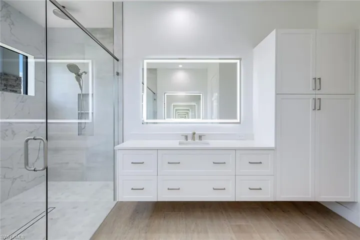 Floating cabinets, LED-backlit mirrors