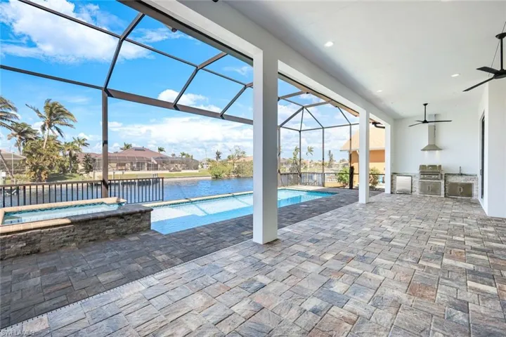 View of the pool and outdoor kitchen from your dinning room