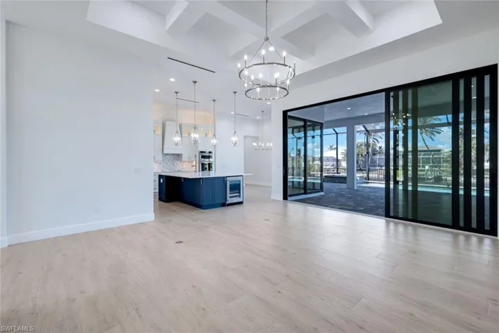 View of living room, kitchen and outdoors from the entrance to the master suit.