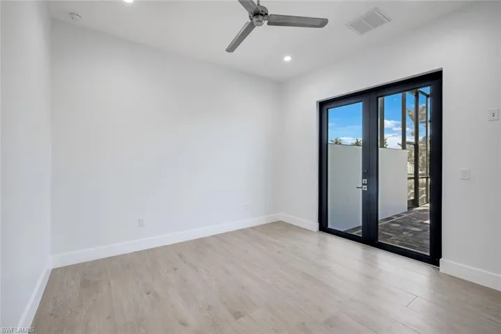 Bedroom 2 with glass door to the pool area