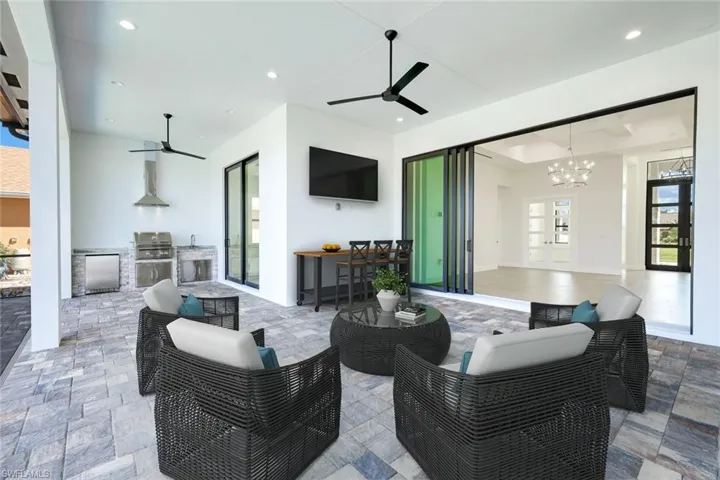 View of patio / terrace featuring an outdoor kitchen, a ceiling fan, and outdoor lounge area