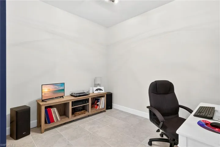 Room featuring light-toned tile flooring and white baseboards