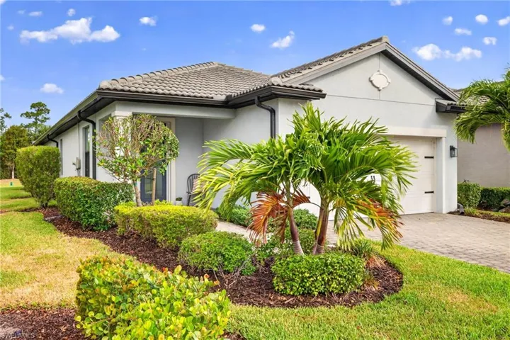 Contemporary stucco exterior with a tiled roof