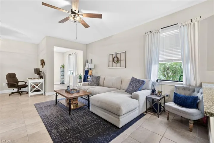 Living area featuring light neutral wall paint and tile flooring