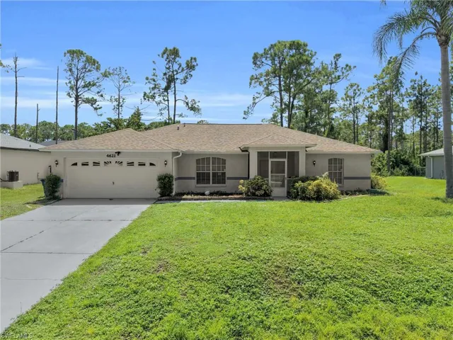 Single-story stucco exterior with an attached garage, screened entryway, arched window, and a gabled roof