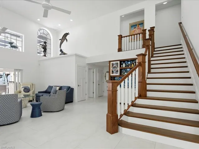 Stairway featuring marble finish floor, recessed lighting, a high ceiling, and a ceiling fan