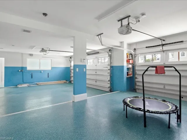 Garage with visible vents and a garage door opener