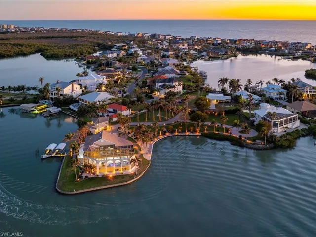 Aerial view at dusk featuring a residential view and a water view