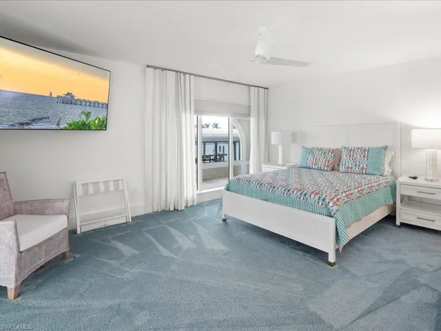 Carpeted bedroom with access to outside and a ceiling fan
