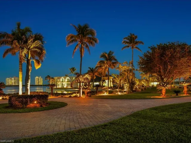 View of community with a lawn and decorative driveway