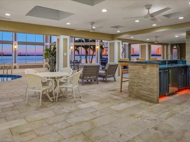 Dining area featuring recessed lighting, a ceiling fan, and a water view