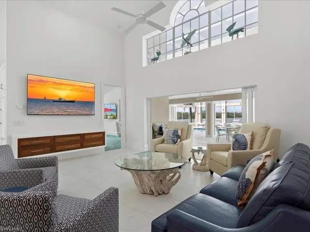 Living area featuring a high ceiling and a ceiling fan