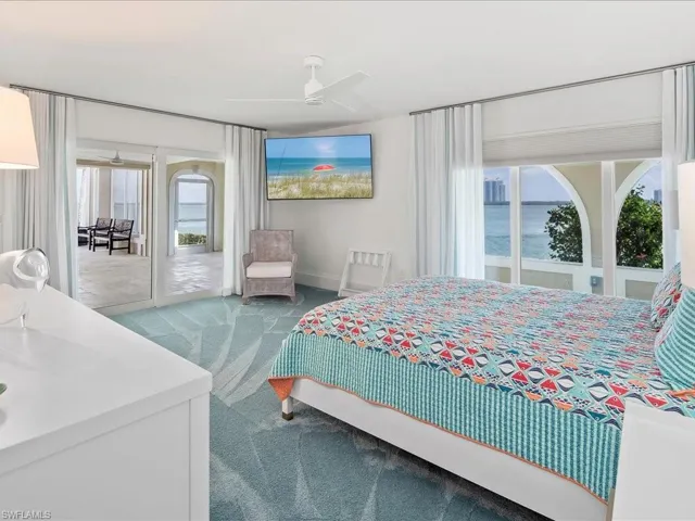 Carpeted bedroom with access to exterior and a ceiling fan