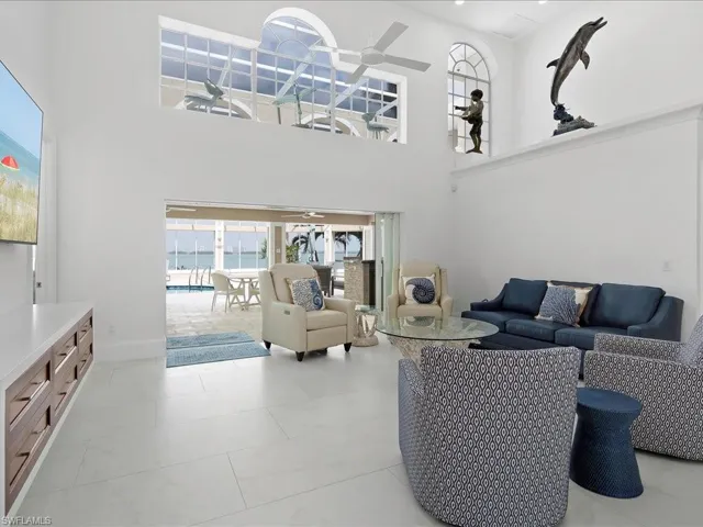 Living area featuring a high ceiling and ceiling fan