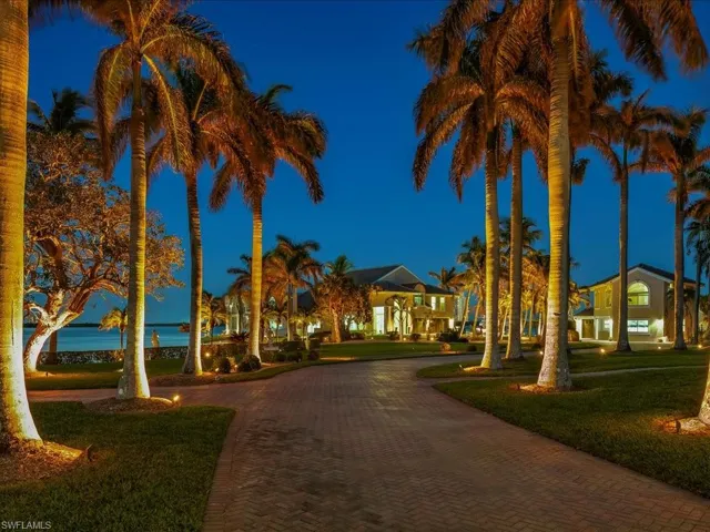 View of community featuring decorative driveway and a lawn