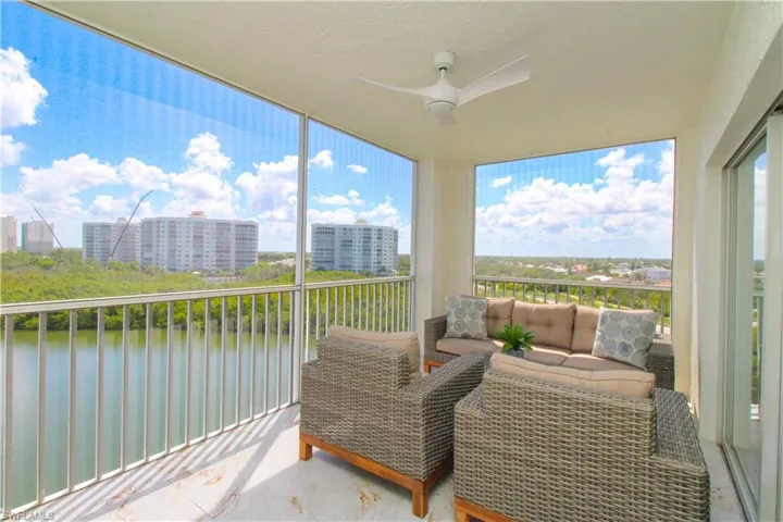 Sunroom / solarium featuring a water view and ceiling fan