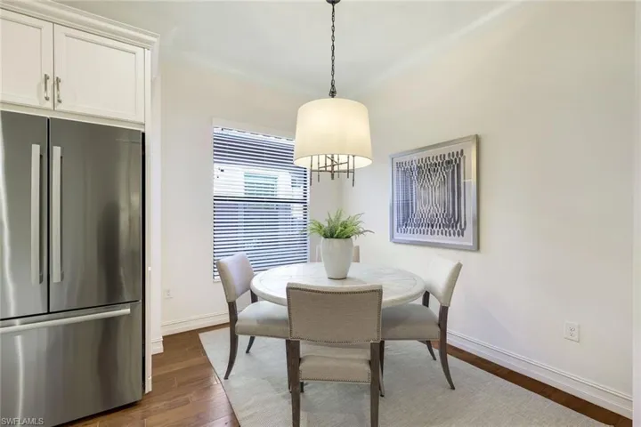 Dining area with crown molding and dark hardwood / wood-style floors