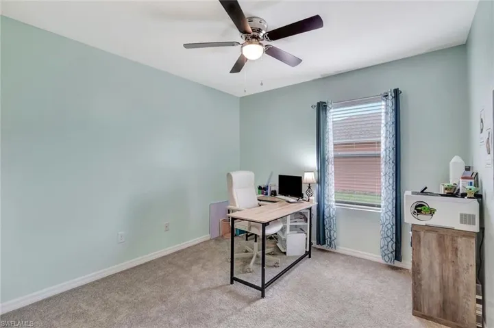 Bedroom with baseboards, ceiling fan, and carpet