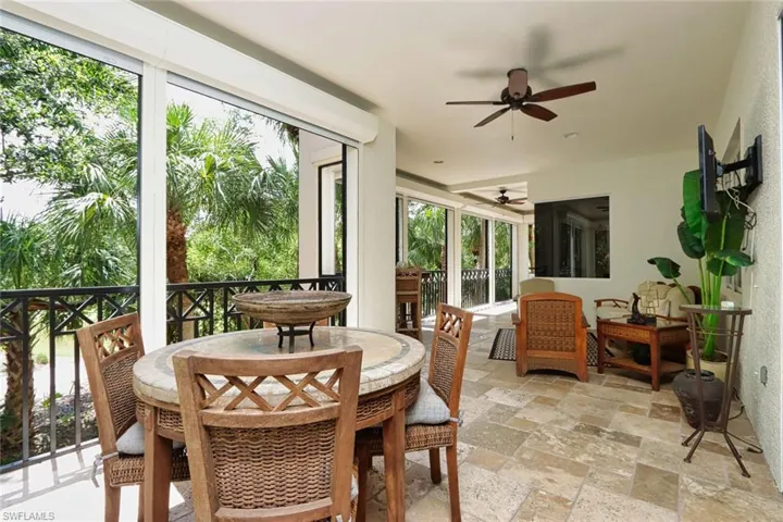 Sunroom with a ceiling fan, healthy amount of natural light, and outdoor dining space