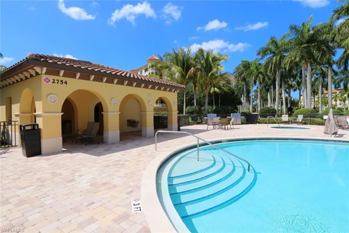 Community pool featuring a patio area and a community hot tub