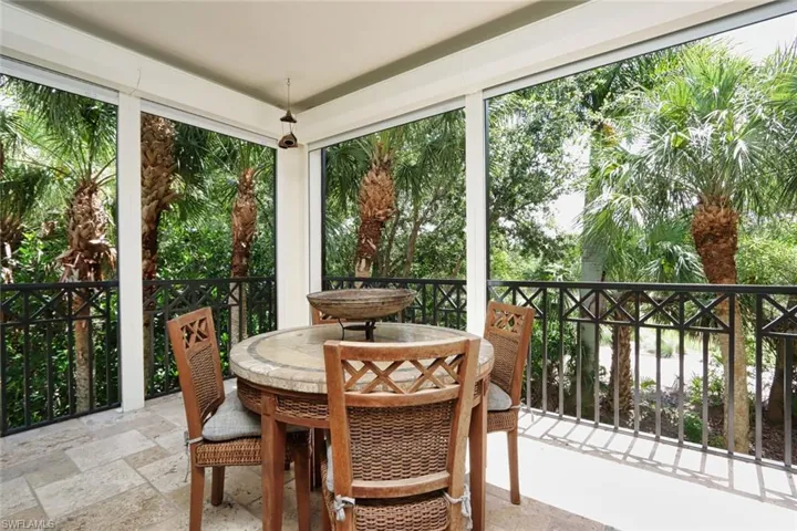 Sunroom / solarium featuring stone tile flooring and outdoor dining area