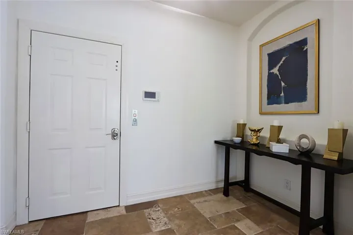 Entryway with stone tile floors and baseboards