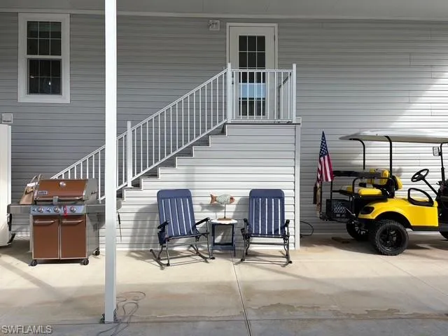 View of patio / terrace with stairs and a grill
