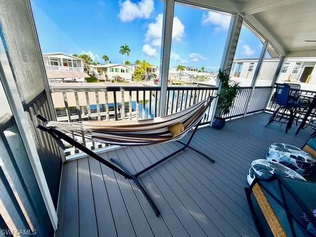 Wooden terrace featuring a sunroom and a residential view