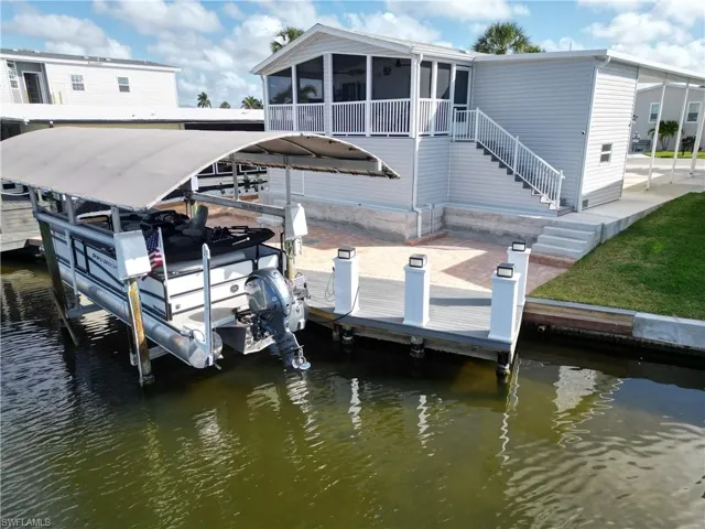 Dock area with boat lift and a water view