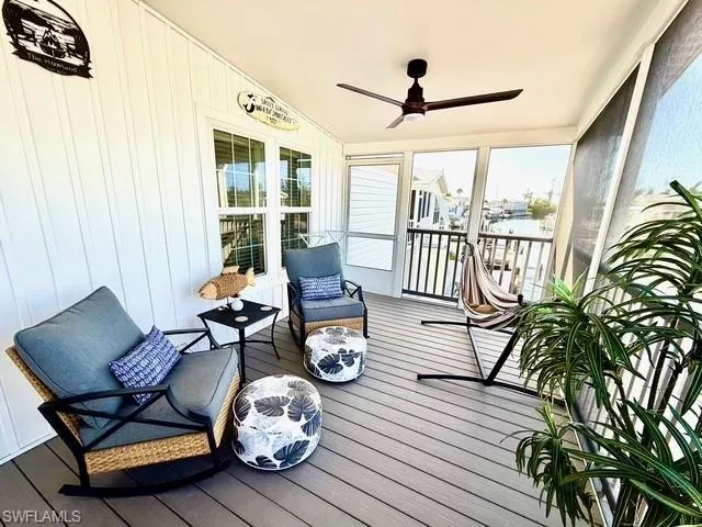 Sunroom featuring a ceiling fan and healthy amount of natural light