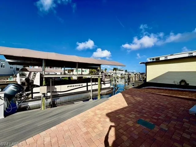 Dock with boat lift and a water view