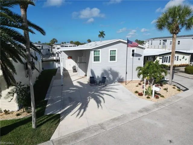 View of front of home featuring an attached carport and driveway