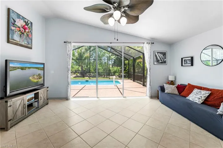 Spacious living area featuring diagonal tile flooring and vaulted ceilings