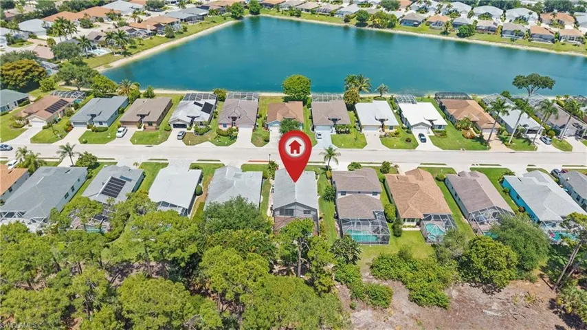 Aerial perspective showcasing a residential street with properties featuring screened patios and private pools