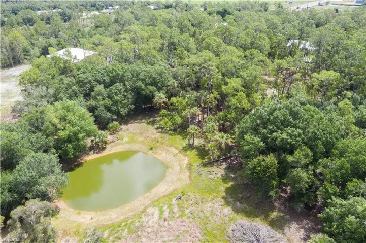Drone / aerial view of a large body of water and a heavily wooded area