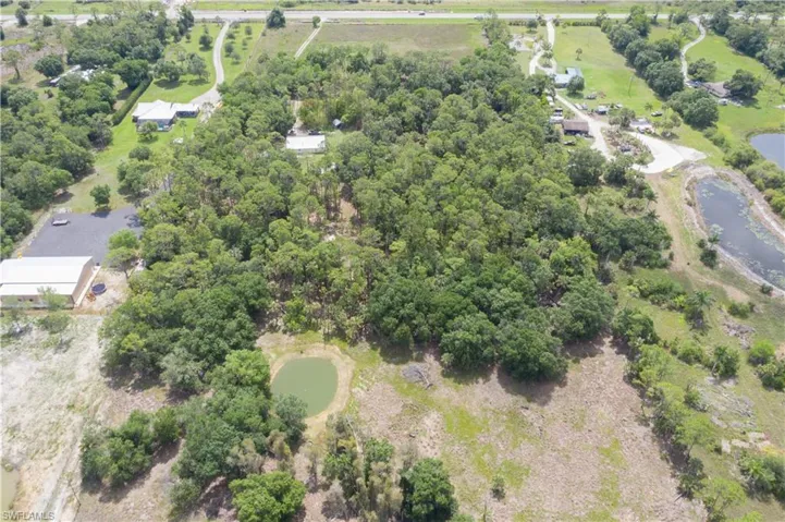 Aerial view of property and surrounding area featuring a large body of water