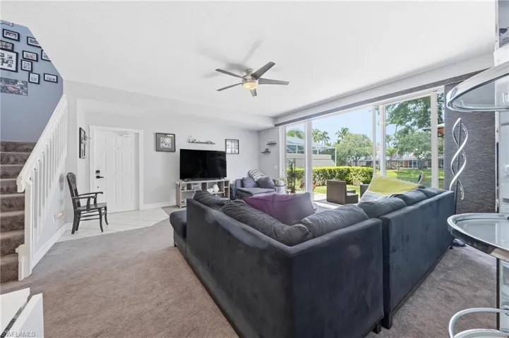 Living area featuring a spacious layout with expansive glass sliding doors