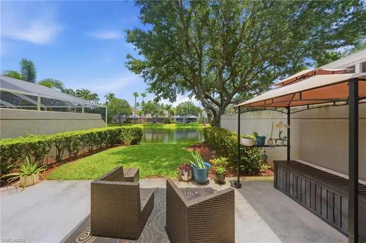 Concrete patio featuring a gazebo, an artificial turf area, and a lush green lawn