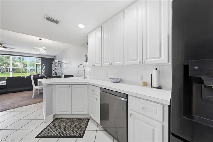 Modern kitchen featuring white shaker cabinetry, white countertops, and a subway tile backsplash